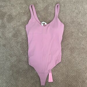 Brand new body suit, removed the tags but never wore it